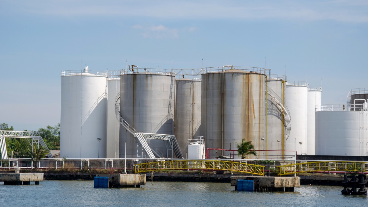 Large steel storage tanks at an industrial terminal